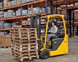Electric forklift moving stacked pallets, powered by 48V forklift lithium battery